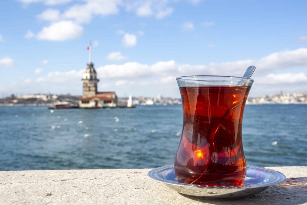 Traditional Turkish tea with a view of the Maiden’s Tower along the Bosphorus in Istanbul, Turkey